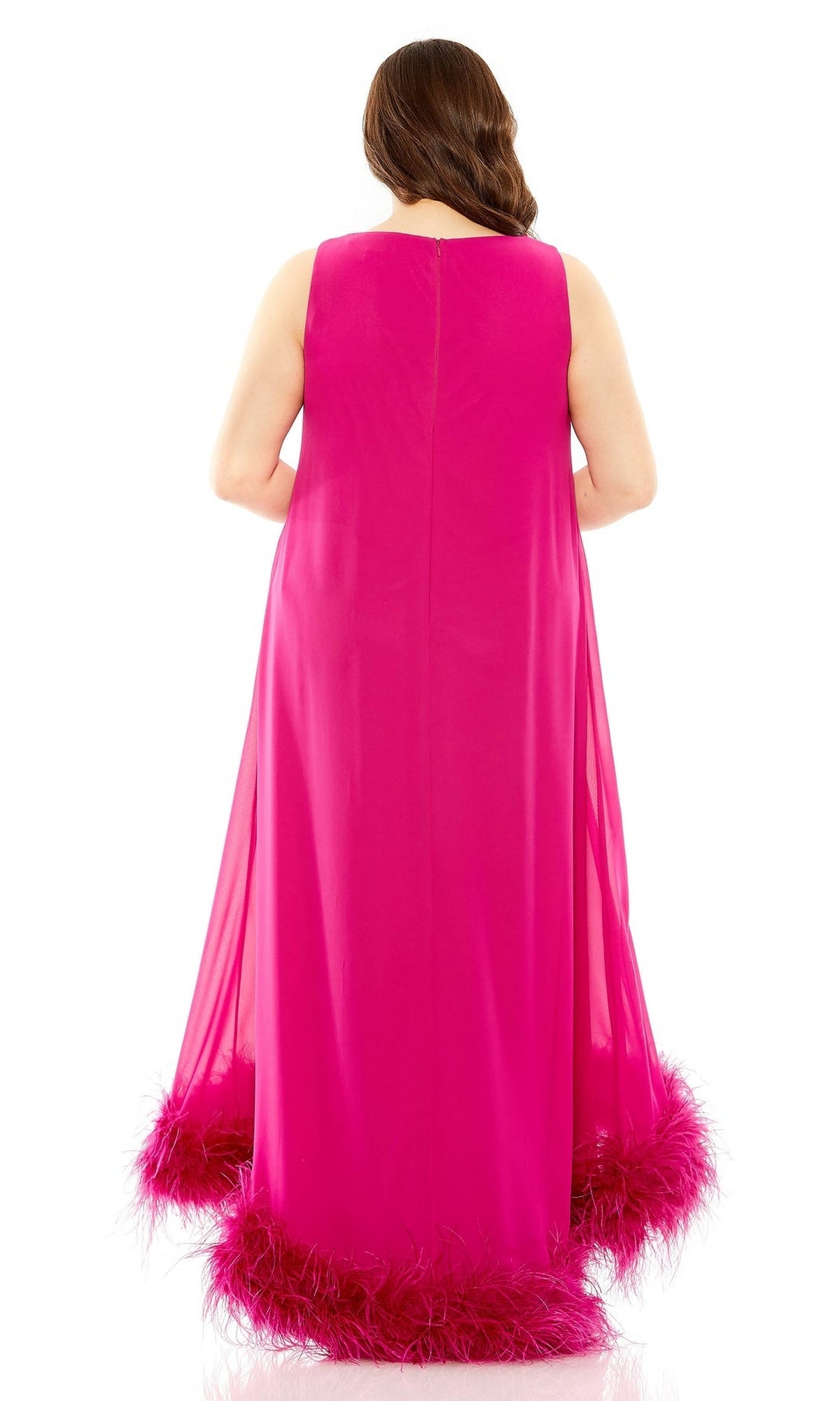 A person stands with their back to the camera in the Plus-Size Long Formal Dress: Mac Duggal 11819, a sleeveless, floor-length fuchsia gown with feather trim at the hem.